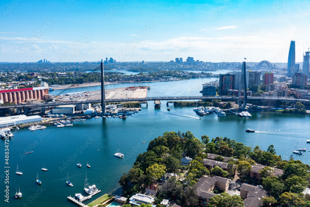 Aerial drone view of Anzac Bridge looking toward Sydney City and Sydney Harbour on a sunny morning