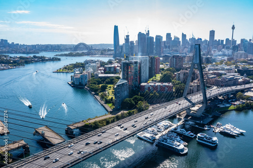 Aerial drone view of Anzac Bridge looking toward Sydney City and Sydney Harbour on a sunny morning photo