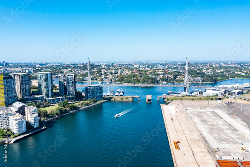 Aerial drone view of Anzac Bridge across Johnstons Bay looking toward Rozelle Bay and Bicentennial Park in Rozelle, Sydney, Australia on a sunny morning 