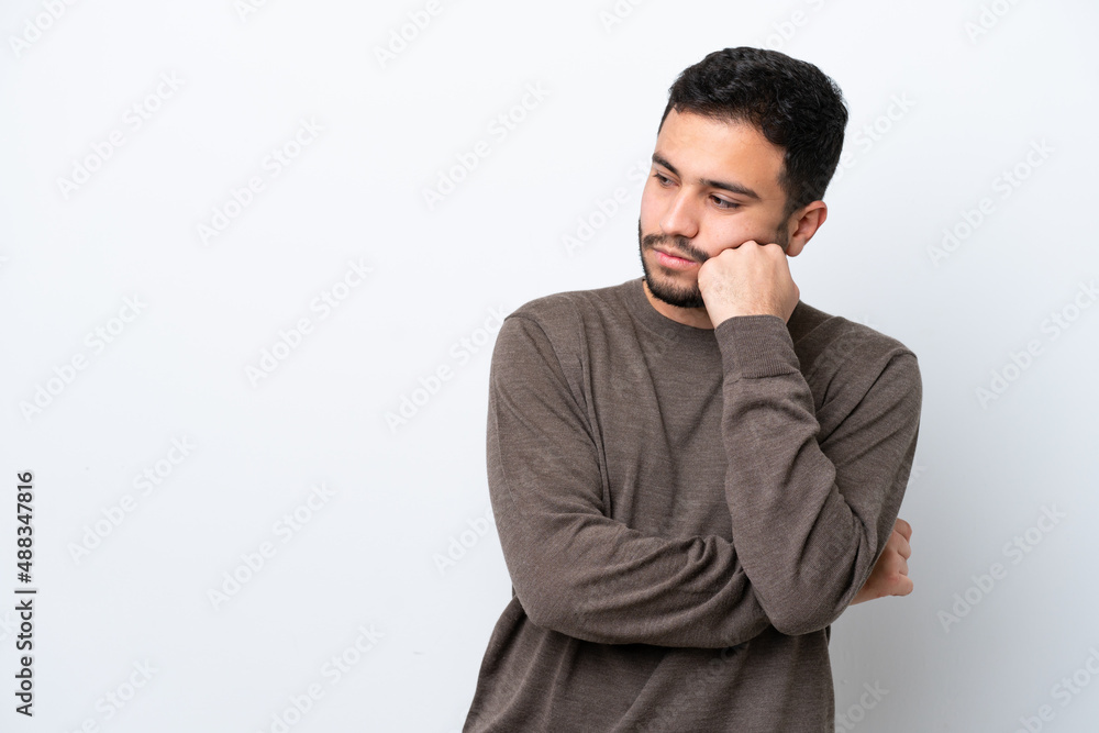 Young Brazilian man isolated on white background with tired and bored expression Young Brazilian man isolated on white background with tired and bored expression