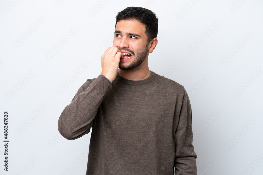 Young Brazilian man isolated on white background is a little bit nervous Young Brazilian man isolated on white background is a little bit nervous