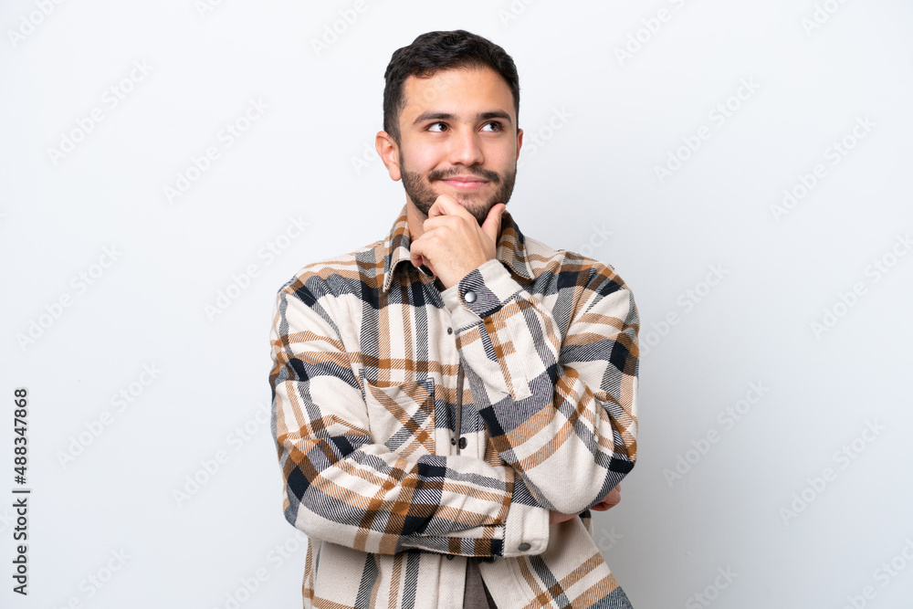 Young Brazilian man isolated on white background thinking an idea while looking up Young Brazilian man isolated on white background thinking an idea while looking up