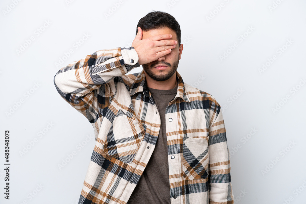 Young Brazilian man isolated on white background covering eyes by hands. Do not want to see something Young Brazilian man isolated on white background covering eyes by hands. Do not want to see something