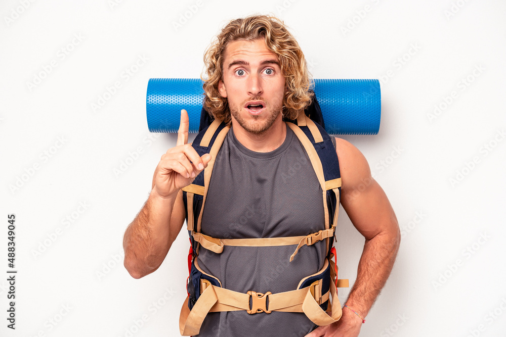 Young mountaineer caucasian man with a big backpack isolated on white background having an idea, inspiration concept. Young mountaineer caucasian man with a big backpack isolated on white background having an idea, inspiration concept.
