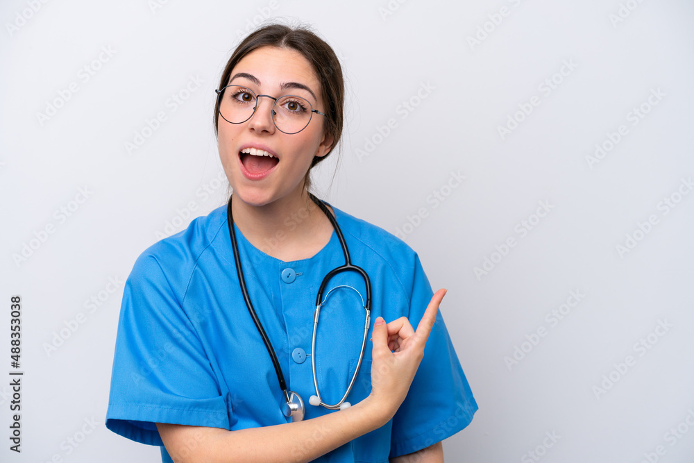 surgeon doctor woman holding tools isolated on white background surprised and pointing side surgeon doctor woman holding tools isolated on white background surprised and pointing side