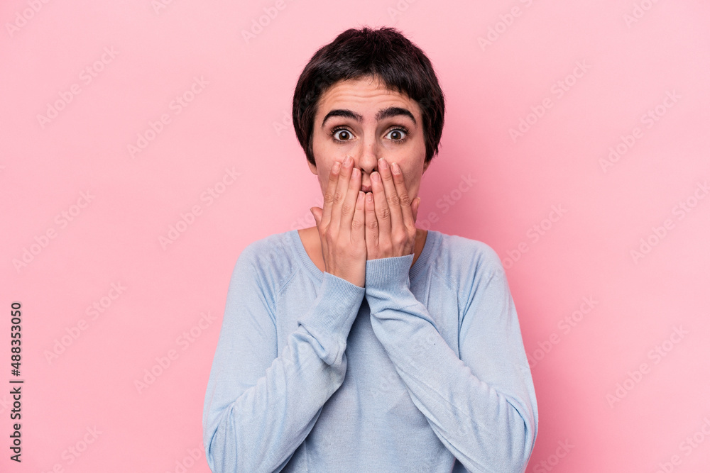 Young caucasian woman isolated on pink background shocked, covering mouth with hands, anxious to discover something new. Young caucasian woman isolated on pink background shocked, covering mouth with hands, anxious to discover something new.