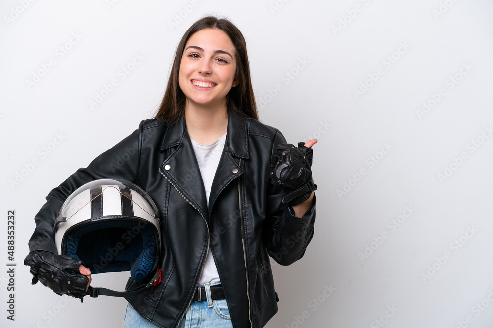 Young girl with a motorcycle helmet isolated on white background pointing to the side to present a product Young girl with a motorcycle helmet isolated on white background pointing to the side to present a product