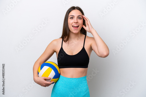 Young caucasian woman playing volleyball isolated on white background with surprise expression