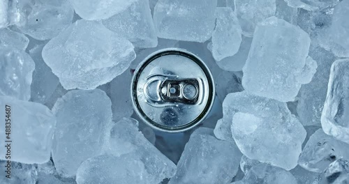 Tin can in ice rotating top view closeup footage