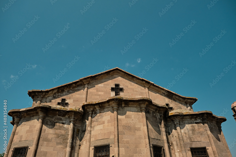 Low angle church view, Triangle shape roof, cross shape and orthodox christianity church in Turkey, uzumlu, Derinkuyu.
