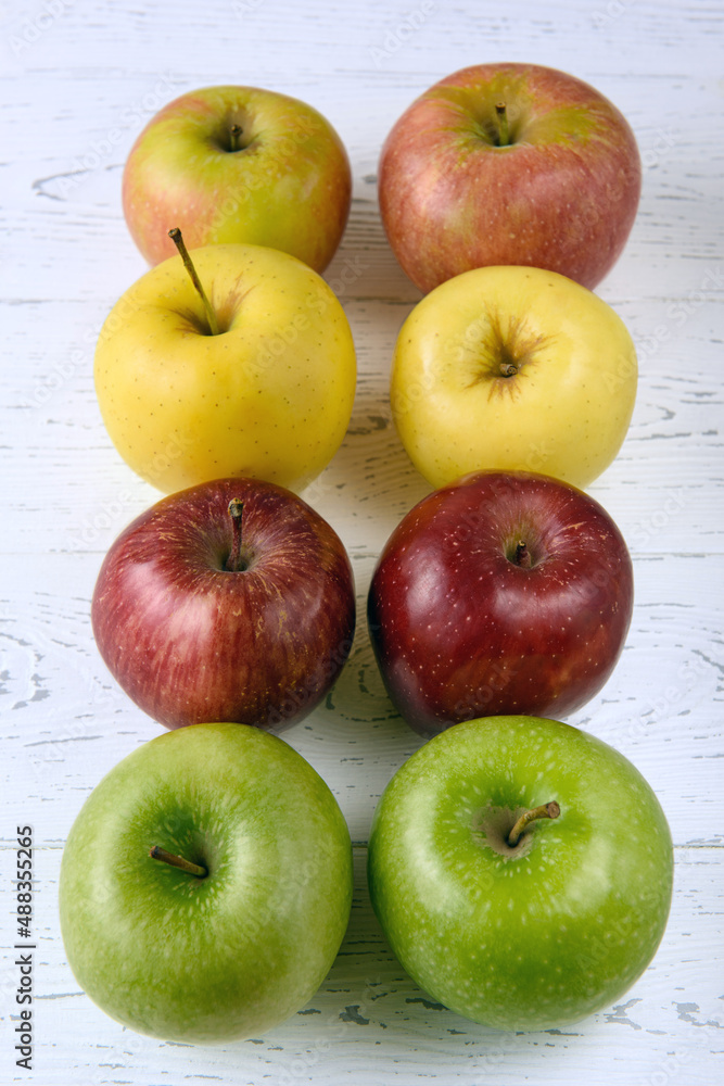 Six multicolored apples on a white wooden background Six multicolored apples on a white wooden background