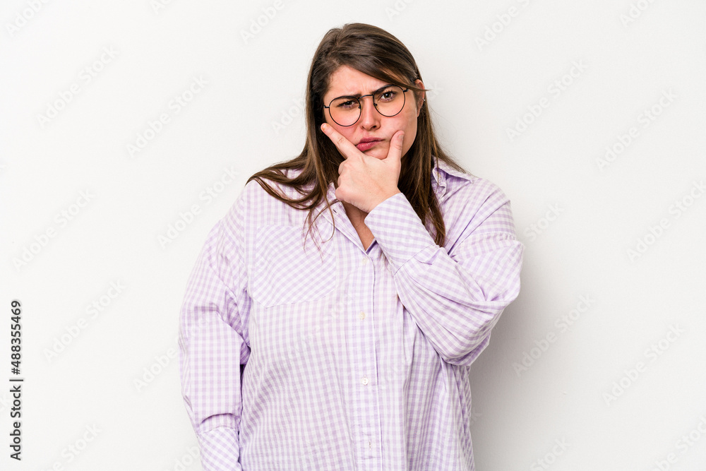 Young caucasian overweight woman isolated on white background contemplating, planning a strategy, thinking about the way of a business. Young caucasian overweight woman isolated on white background contemplating, planning a strategy, thinking about the way of a business.