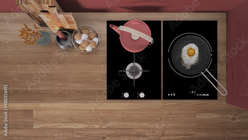 Vászonkép Red and wooden kitchen close up, induction and gas hob with pot and fried egg in a pan