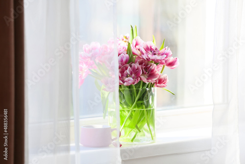 Vase with beautiful tulip flowers on windowsill © Pixel-Shot