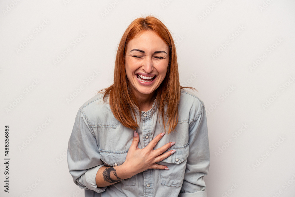 Young caucasian woman isolated on white background laughs out loudly keeping hand on chest. Young caucasian woman isolated on white background laughs out loudly keeping hand on chest.