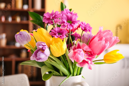 Wall Mural Bouquet of beautiful flowers in kitchen, closeup