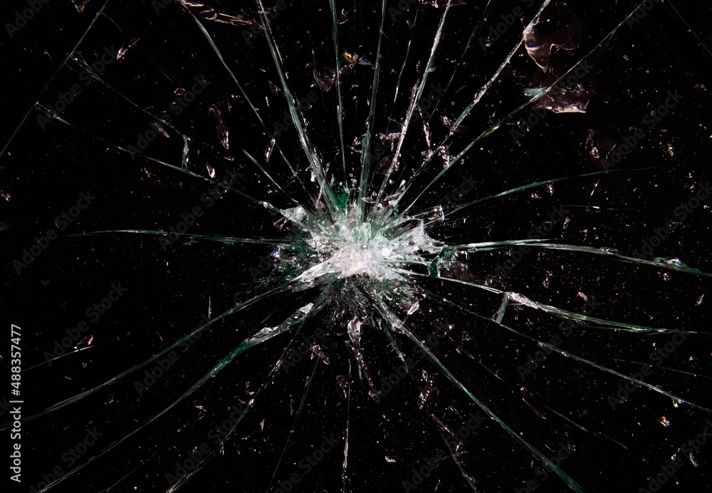 A broken glass on a black background, a big hole at the center and many shattered pieces around it. A useful texture, overlay or background.
A broken glass on a black background, a big hole at the center and many shattered pieces around it. A useful texture, overlay or background.