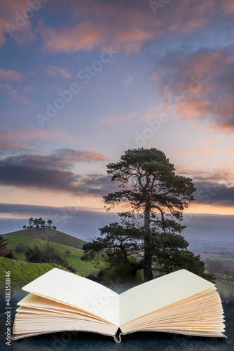 Beautiful vibrant sunrise landscape image of Colmer's Hill in Dorset on a Spring morning in pages of reading book digital composite