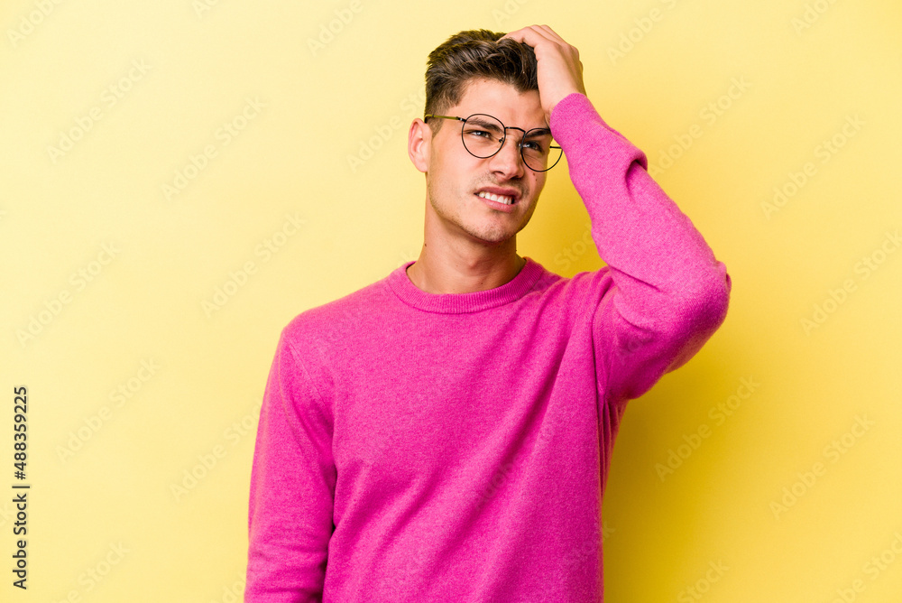 Young caucasian man isolated on yellow background forgetting something, slapping forehead with palm and closing eyes. Young caucasian man isolated on yellow background forgetting something, slapping forehead with palm and closing eyes.