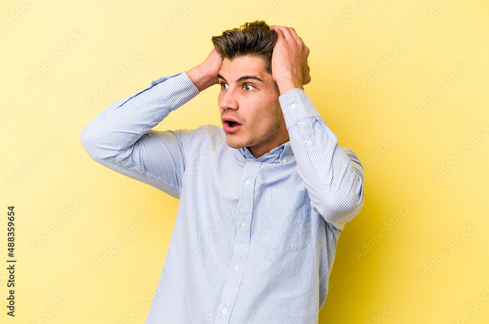 Young caucasian man isolated on yellow background screaming, very excited, passionate, satisfied with something. Young caucasian man isolated on yellow background screaming, very excited, passionate, satisfied with something.