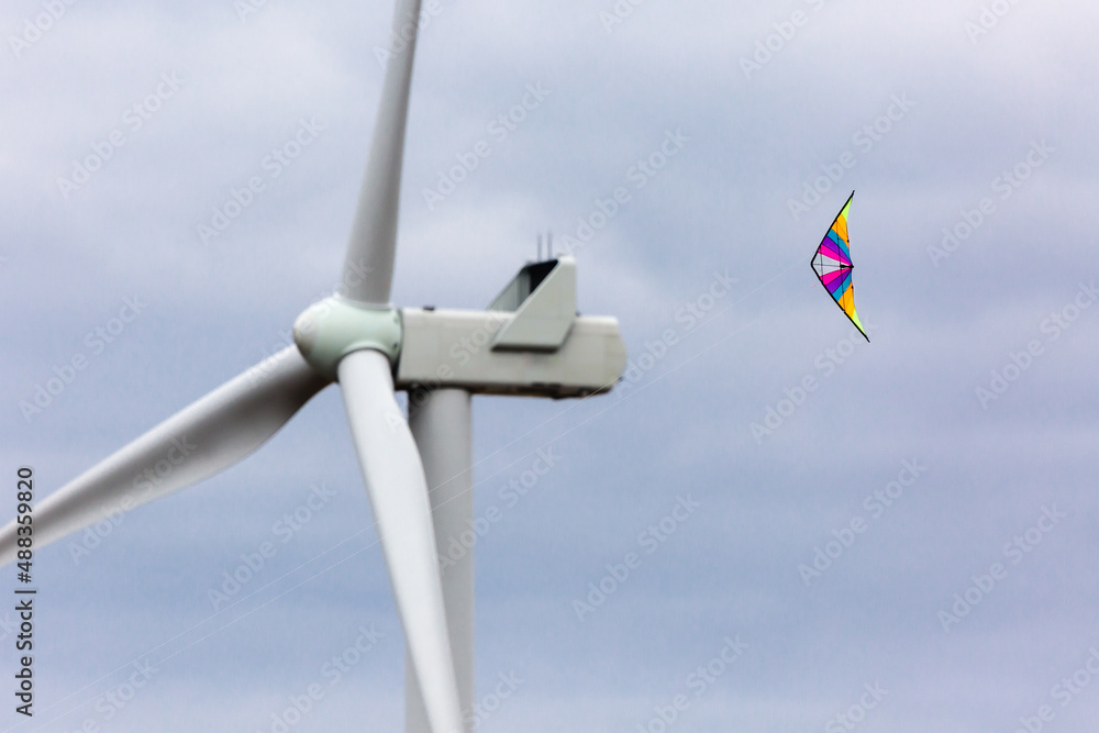 kite flying near the wind turbine kite flying near the wind turbine