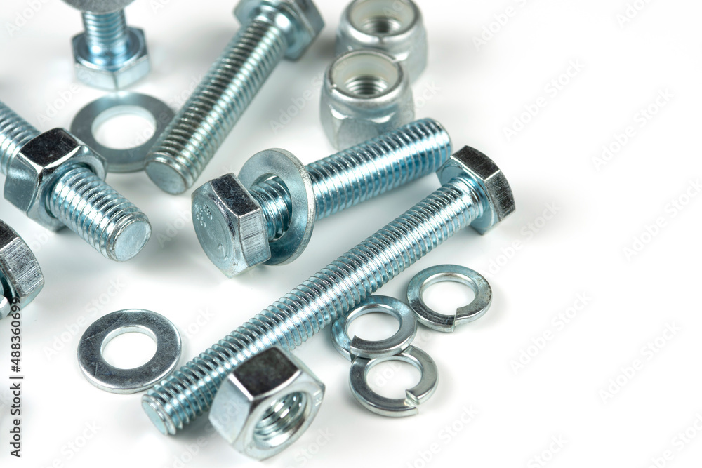 metal bolts and nuts with round washers close-up on a white background. copy space metal bolts and nuts with round washers close-up on a white background. copy space