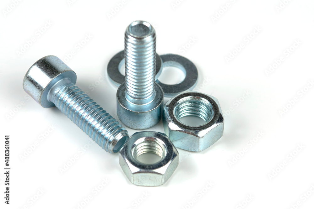 metal bolts and nuts with round washers close-up on a white background metal bolts and nuts with round washers close-up on a white background