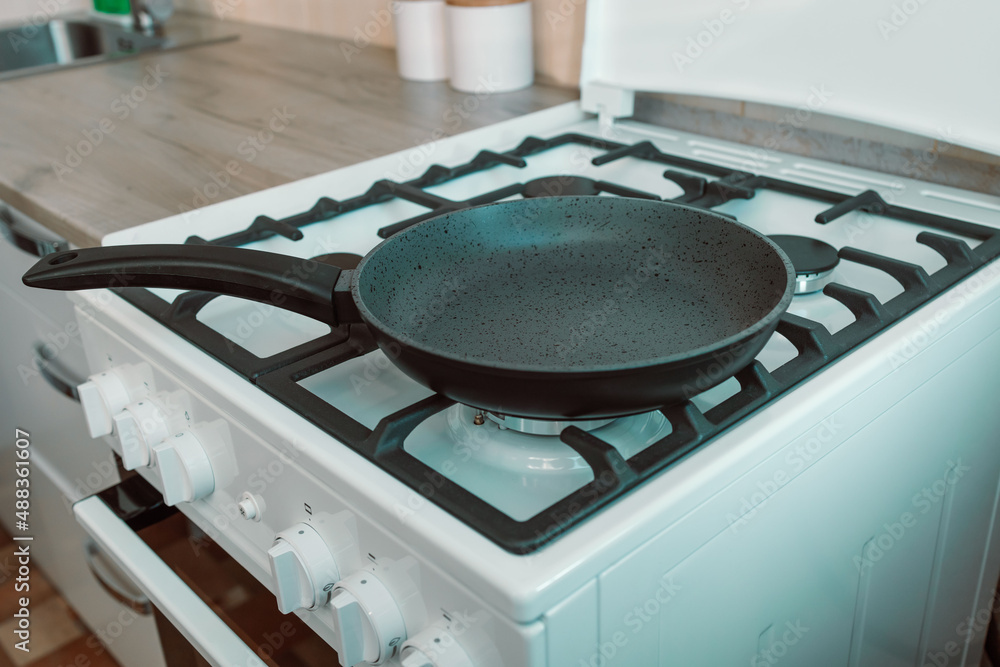 Frying pan on new gas stove in kitchen Frying pan on new gas stove in kitchen