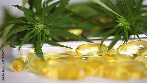 Cannabis CBD oil in capsules essential oil, close up. Hemp oil capsules as an option for treatment