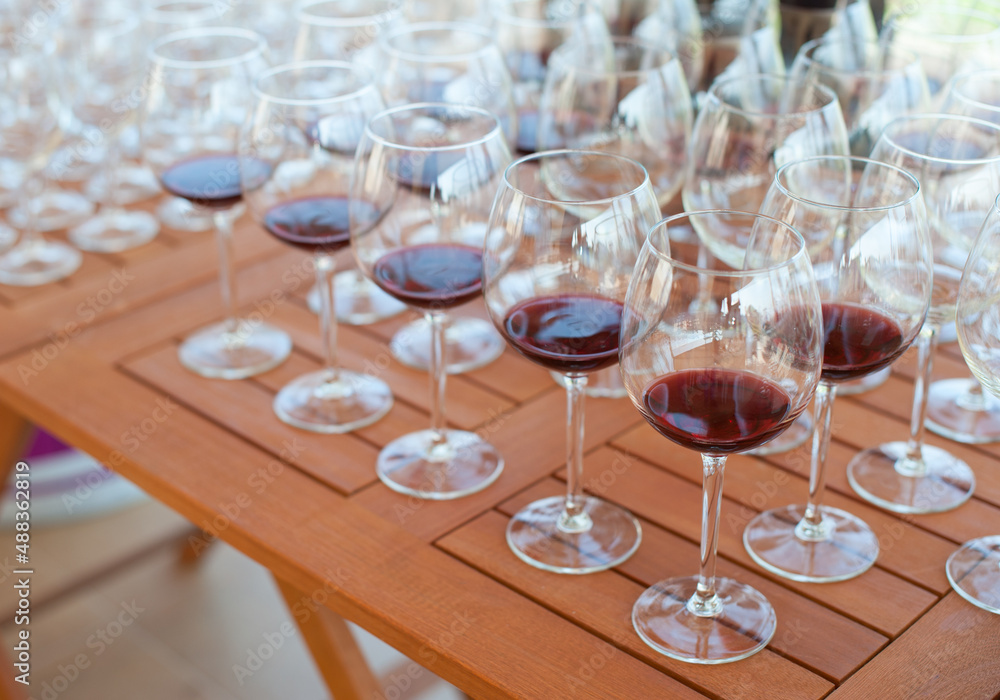 A lot of glasses with wine on the table for tasting A lot of glasses with wine on the table for tasting