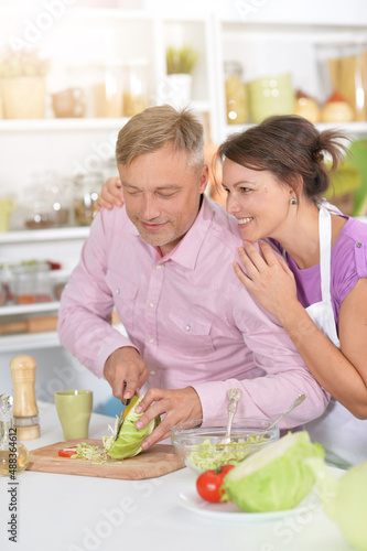 Couple doing salad in the kitchen at home