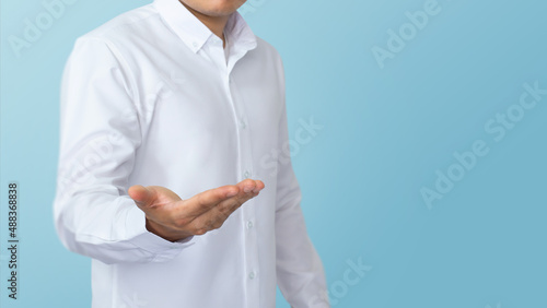 Businessman hand on product presentation gesture on blue background. Business concept