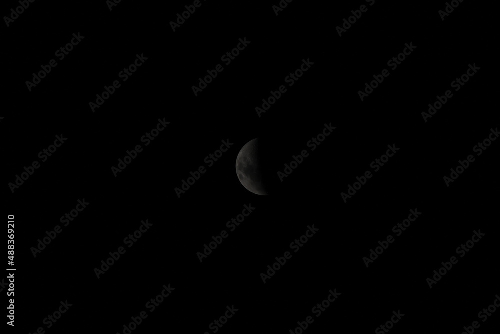 half moon shadow on an isolated dark background. half moon shadow on an isolated dark background.