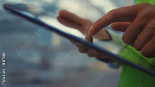 Engineer holding tablet touching screen check product information hands closeup © stockbusters
