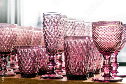 Green goblets and glasses for wine in the store on the counter transparent set collection embossed