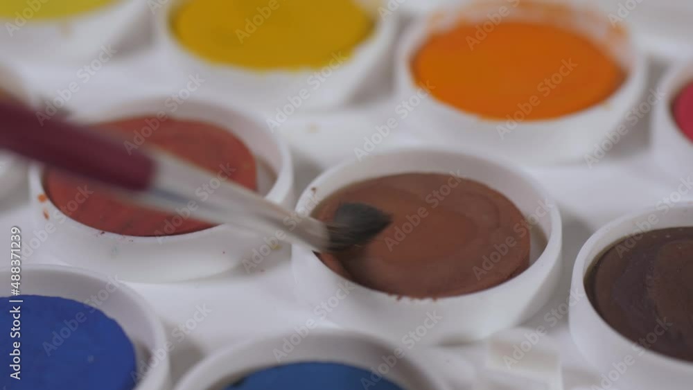 artist painter mixing water and brown watercolor with brush slow motion 4k artist painter mixing water and brown watercolor with brush slow motion 4k