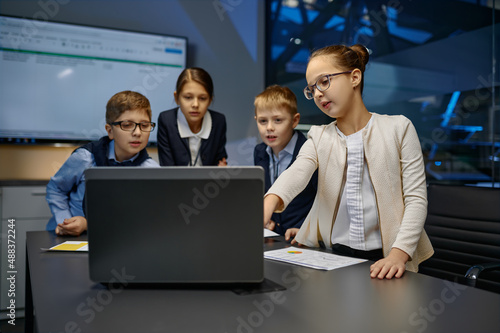 Diverse children business team analyzing financial data