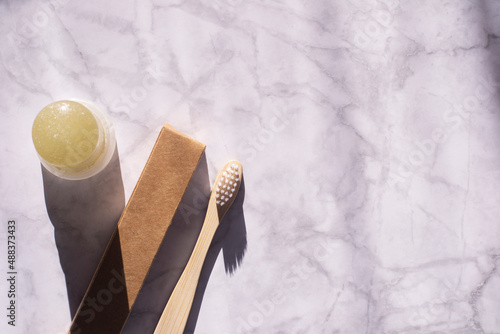 Wallpaper Mural Wooden toothbrush with paper packaging and alunite deodorant on a marble background. Eco-friendly body care solutions. Top view of eco toothbrush and deodorant.  Torontodigital.ca