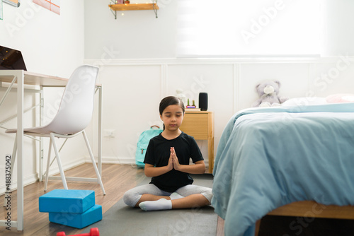 Active kid relaxing with a yoga workout