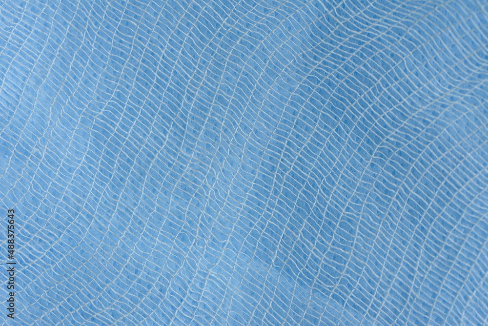 medical bandage and Blue spunbond texture background. homemade virus Pandemic Protection Concept. close up surface of spunbond. Medical face mask material medical bandage and Blue spunbond texture background. homemade virus Pandemic Protection Concept. close up surface of spunbond. Medical face mask material