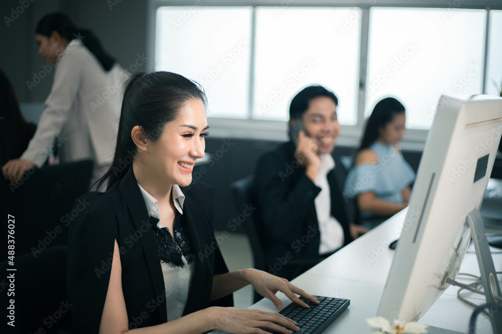 Smiling business casual women use laptop computer at office Smiling business casual women use laptop computer at office