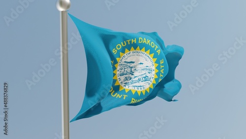 South Dakota flag on flagpole. SD flag fluttering in the wind. USA. photo