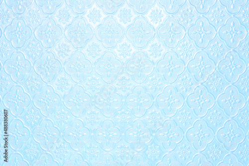 Textured pale light blue faded background with a pattern of painted glass in vintage style wall