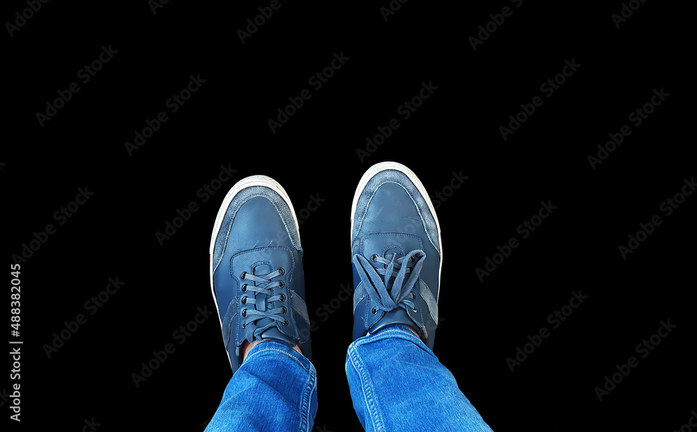 top view of blue sneakers with jean pants isolated on background with clipping path. top view of blue sneakers with jean pants isolated on background with clipping path.