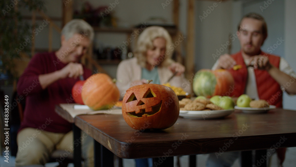 © iaginzburg - Young woman takes a slice of pumpkin from the dinner table and tastes