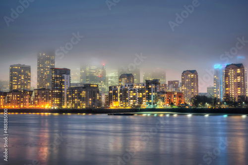 Foggy Canary Wharf in London at night