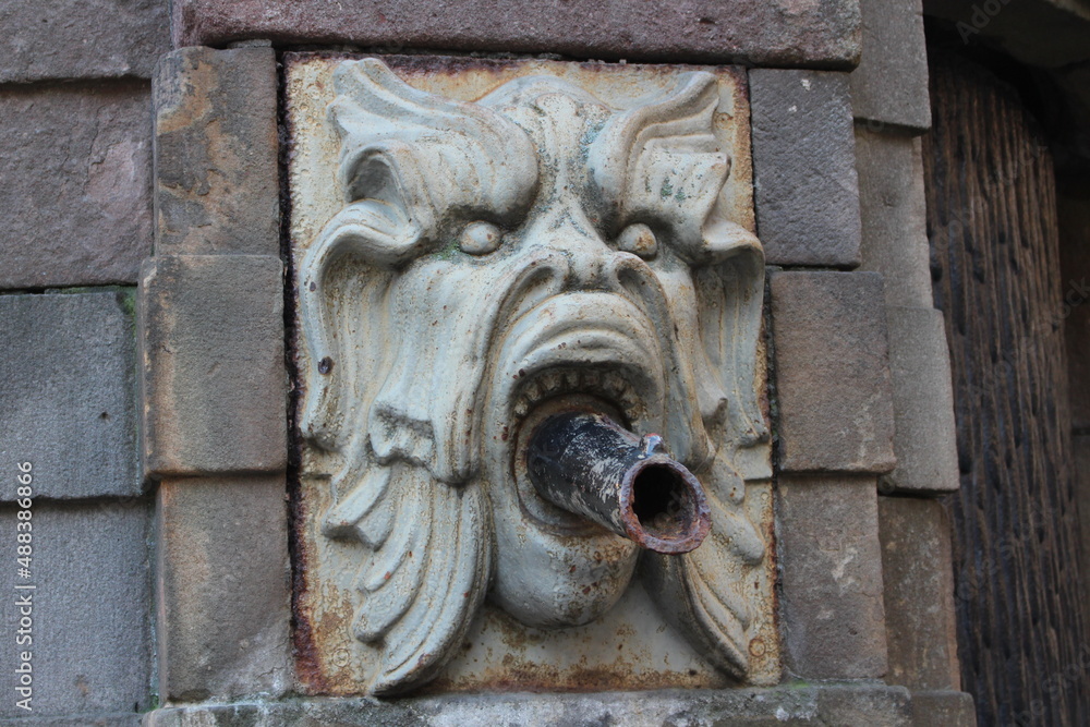 Stokholm. Sweden. 16 january 2019. Gargoyle Fountain at Stortorget Square In Stockholm Old Town Gamla Stan Stockholm Sweden. Stone scary muzzle of an antique water fountain.