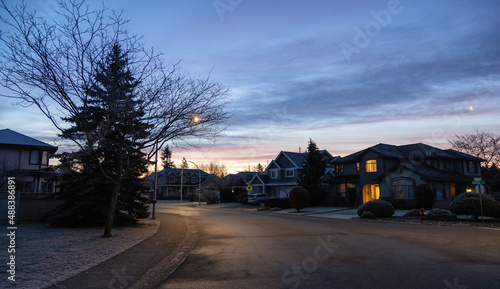 View of Residential Suburban Neighborhood Street in a modern city. Frosty Cloudy Winter Morning Sunrise Sky. Fraser Heights, Surrey, Vancouver, British Columbia, Canada. © edb3_16