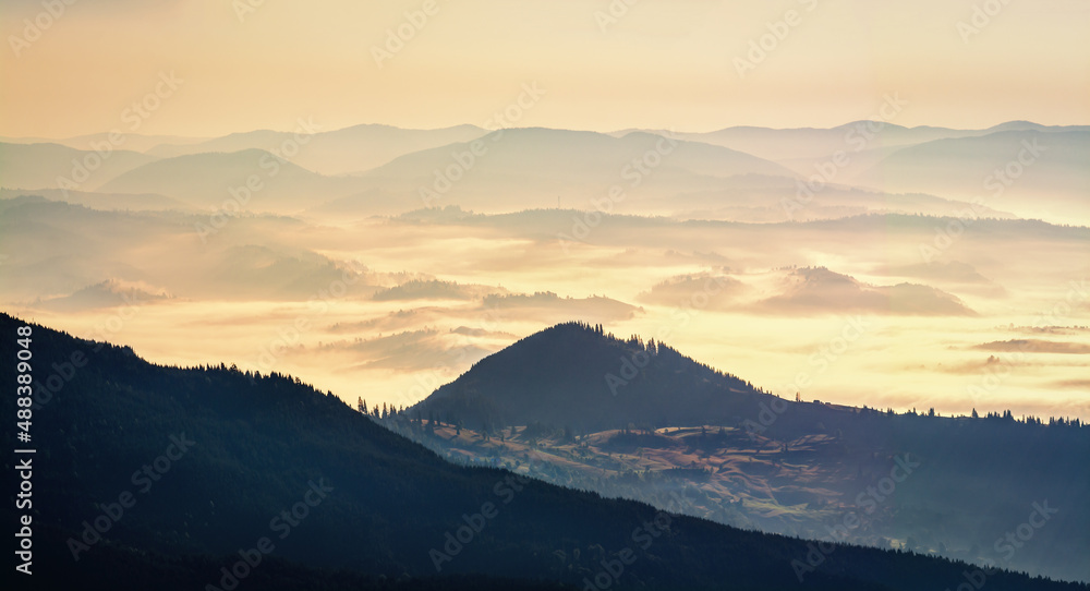 Beautiful sunrise in the Carpathians. Hills lines during sunrise. Beautiful natural landscape. Vibrant photo. Panoramic view.
