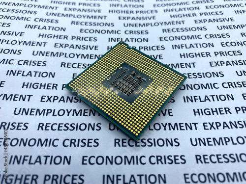 Expensive microprocessor chip closeup view on a paper with text economic crises, recession, unemployment photo